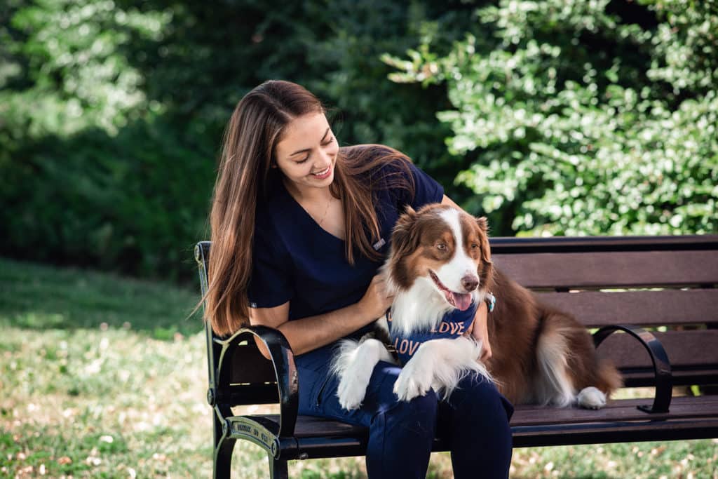 Basic Tips For Creating a Healthier Life for You and Your Pet | Boulder Vet | girl sitting with her dog on a bench in a park